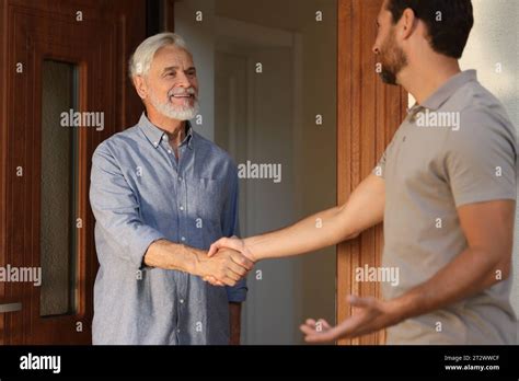 Friendly Relationship With Neighbours Happy Men Shaking Hands Near