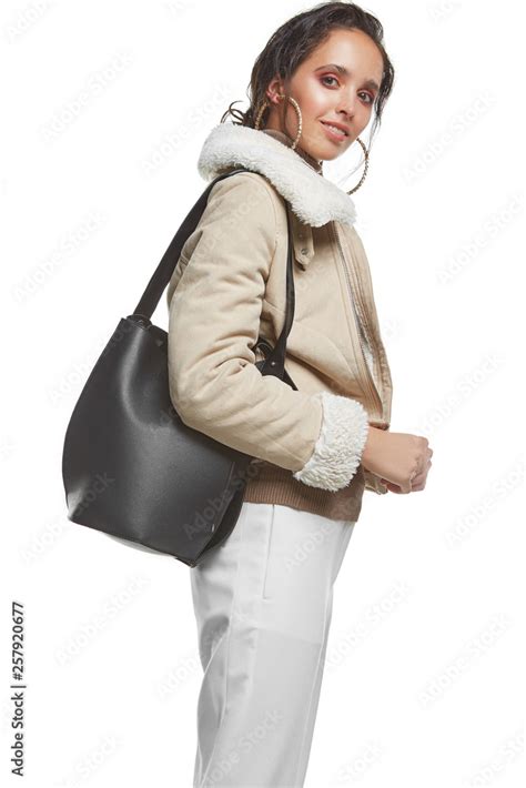 Three Quarter Side Shot Of Lady Wearing Short Shearling Coat And White