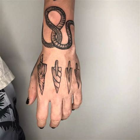 A Person S Hand With Tattoos On It