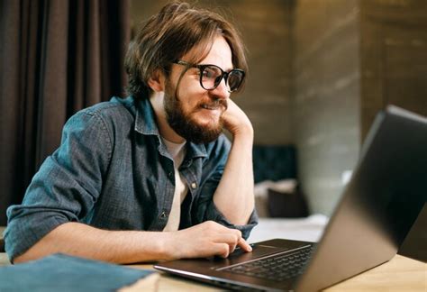 Premium Photo Young Smiling Bearded Man Wearing Glasses Watching