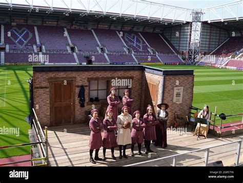 The Cast Of Sweet Fa Performing On A Make Shift Stage In The Stand At