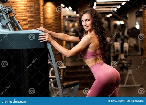 Fitness Brunette Girl Is Standing Near Training Apparatus And Posing