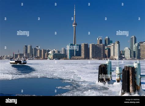 Wards Island Ferry returning to Toronto in winter keeping a channel ...