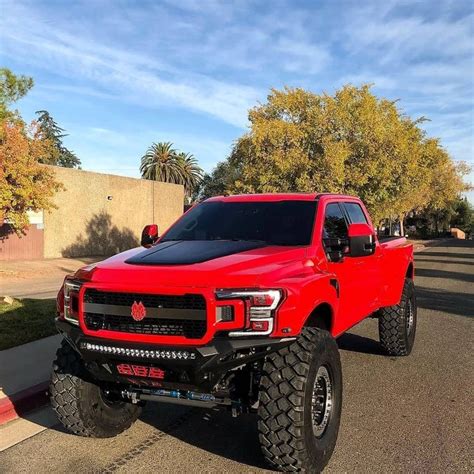 a red pick up truck parked on the street