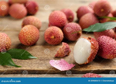 Fresh Ripe Lychees With Leaves On Wooden Table Closeup Stock Image