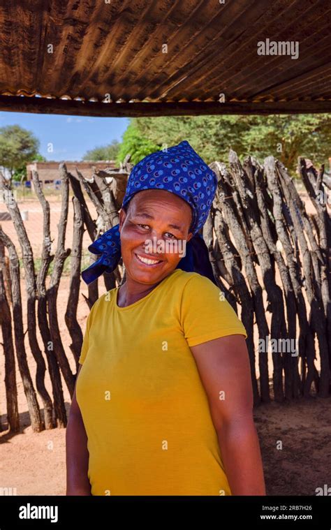 Portrait Of An African Village Woman Standing In The Yard Outdoors Kitchen In Rural Area Stock