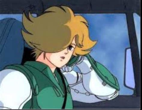 An Anime Character With Blonde Hair And Green Vest Sitting In A Car