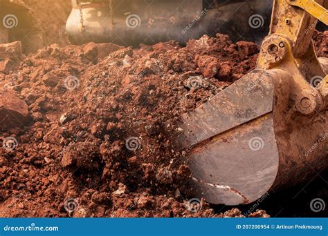 Closeup Bucket Of Backhoe Digging The Soil At Construction Site