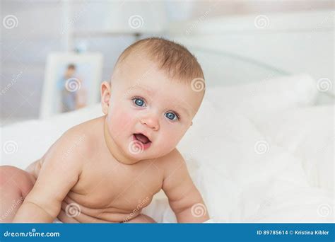 Portrait Of Naked Smiling Infant Sits On A Bed In Bedroom Stock Photo Image Of Female Glad