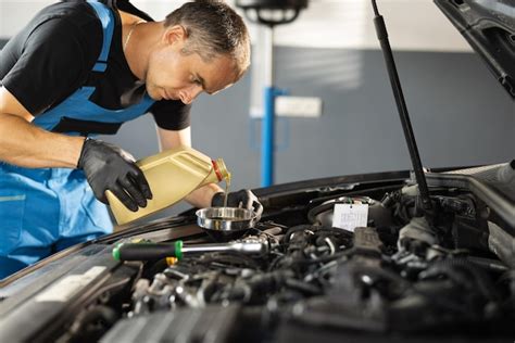 Premium Photo The Mechanic Is Pouring Oil Into The Engine Pouring