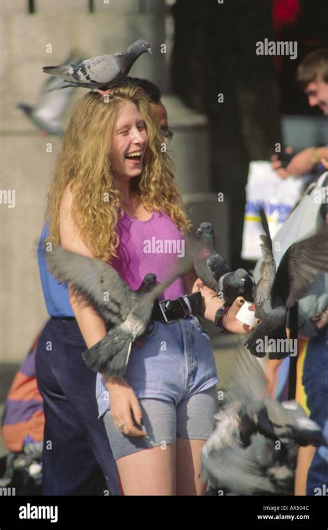 Trafalgar Square tourist feeding pigeons, London, UK Stock Photo - Alamy