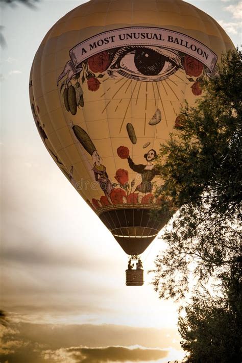 Vertical Shot Of A Hot Air Balloon With Eye Design At Sunset Editorial Photography Image Of