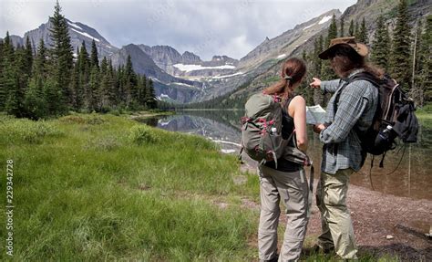 Hiker with hiking map in Glacier National Park, Montana, USA Stock Photo | Adobe Stock