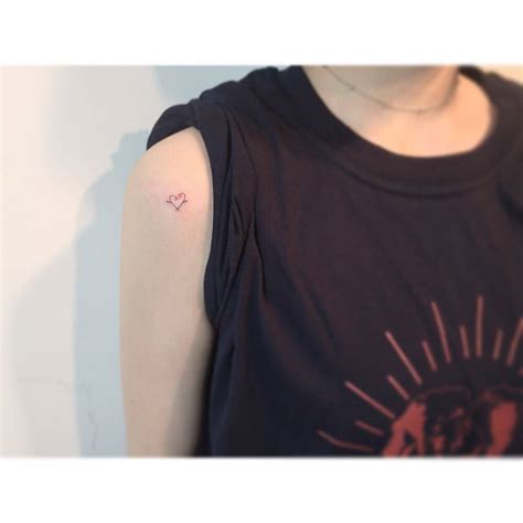 Minimalistic Style Flower Heart Tattoo Located On The