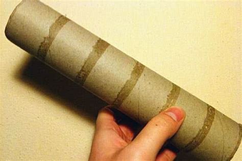 A Hand Holding A Rolled Up Piece Of Paper