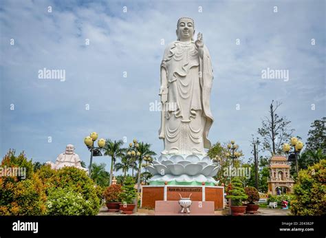 Standing Buddha statue at Vinh Trang Pagoda, Vietnam Stock Photo - Alamy