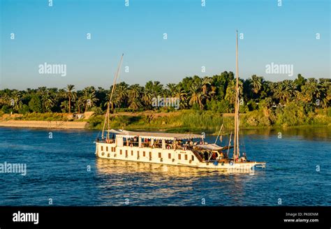 Passengers On Deck Of Tourist Cruise Boat With Sailing Masts Being