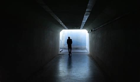 Premium Photo Person Walking In Dark Tunnel Exit