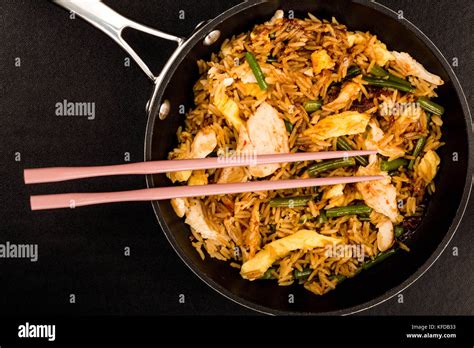 Indonesian Style Nasi Goreng Chicken And Rice Meal Against A Black