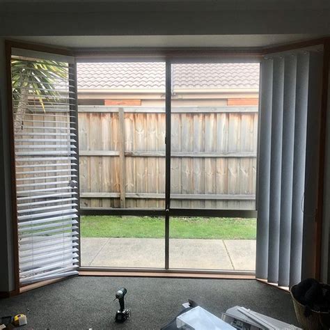 A Living Room With Sliding Glass Doors That Look Out Onto A Backyard