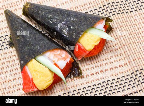 Hand Rolled Temaki Sushi Traditional Japanese Cuisine On Wooden Mat