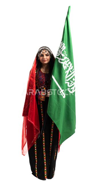 Portrait Of A Saudi Arabian Gulf Woman Raising The Saudi Flag Wearing