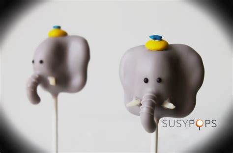 Two Elephant Lollipops Sitting On Top Of Each Other In Front Of A White