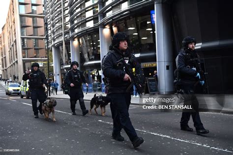 Armed Police With Dogs Patrol Along Cannon Street In Central London