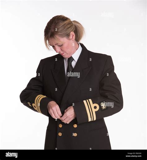 Lt Commander female South African naval officer getting dressed into ...