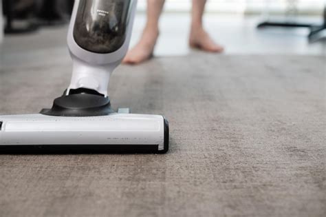 Premium Photo | Carpet cleaning with a vacuum cleaner closeup