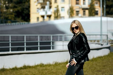 Street Shot Of Gorgeous Blonde Model Wearing Leather Jacket And Glasses