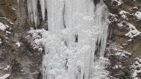 Ice Climber On Frozen Waterfall Aerial Stock Video Clip K