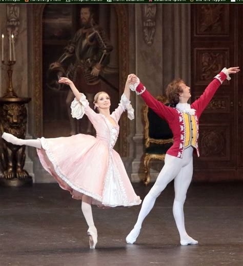 Two Ballerinas Dressed In Red And White Are Performing On Stage With