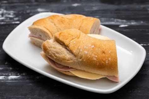 A Spanish Rosca De Jamon Serrano Ham Sandwich On A White Plate Stock