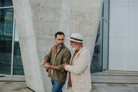 Mature Son And Father Traveling Together Looking At Map On Phone Stock Image Image Of