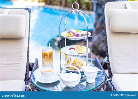 Afternoon Tea Set With Latte Coffee And Hot Tea On Table Neary Chair