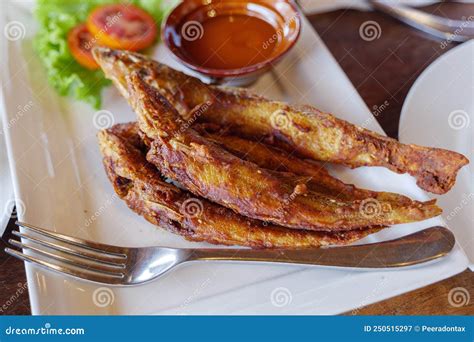 Fried Whiting Fish with Garlic and Turmeric. Stock Image - Image of