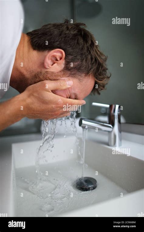 Man In The Bathroom Washing His Face Hi Res Stock Photography And