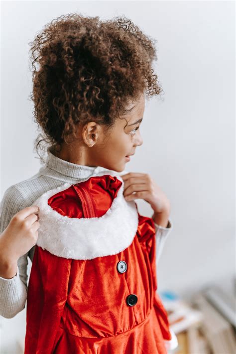 Cheerful black girl with Santa Claus costume · Free Stock Photo