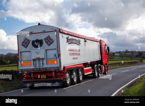 DAF XF Heavy Truck Pulling A Bulk Tipper Trailer Driving On A Narrow