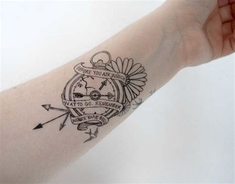 A Person S Arm With A Compass Tattoo On It