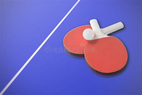 Ping Pong Paddles And A Ball On A Blue Table Empty Copy Space Stock