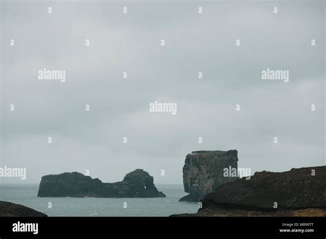 Majestic Icelandic Landscape With Cliffs In Ocean And Cloudy Sky Vik