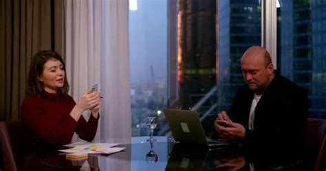 A Brunette And A Bald Man Sit At A Round Stock Video Pond