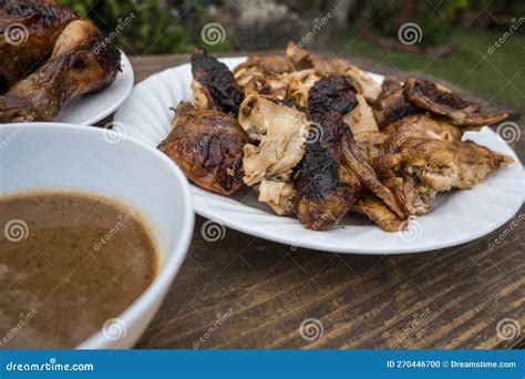 A Plate Of Chopped Lechon Manok Or Roasted Chicken Served Outside At A