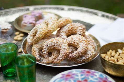 A Table Topped With Plates And Bowls Filled With Donuts