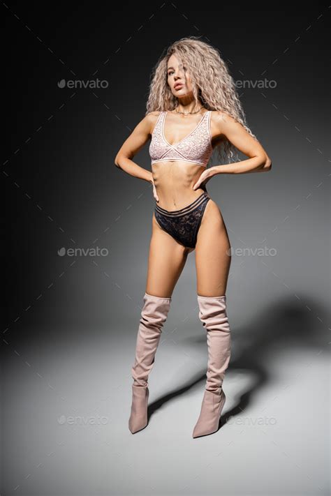 Full Length Of Stylish And Seductive Woman With Wavy Ash Blonde Hair And Slender Body Posing