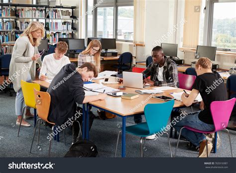 Busy College Library Teacher Helping Students Stock Photo 765916981