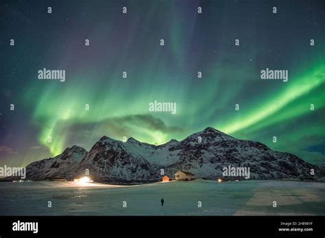 Aurora Borealis Northern Lights Over Snow Mountain Range In Skagsanden