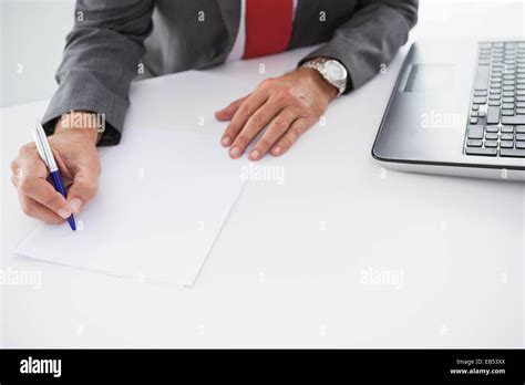 Mature Businessman Writing On Document Stock Photo Alamy